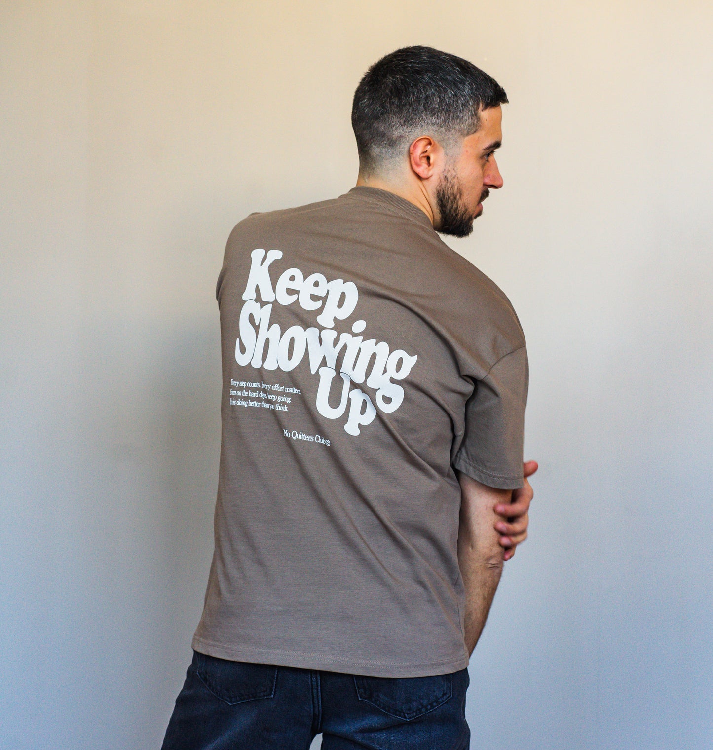Unisex everyday outfit featuring mocha “Keep Showing Up” tee – lifestyle look