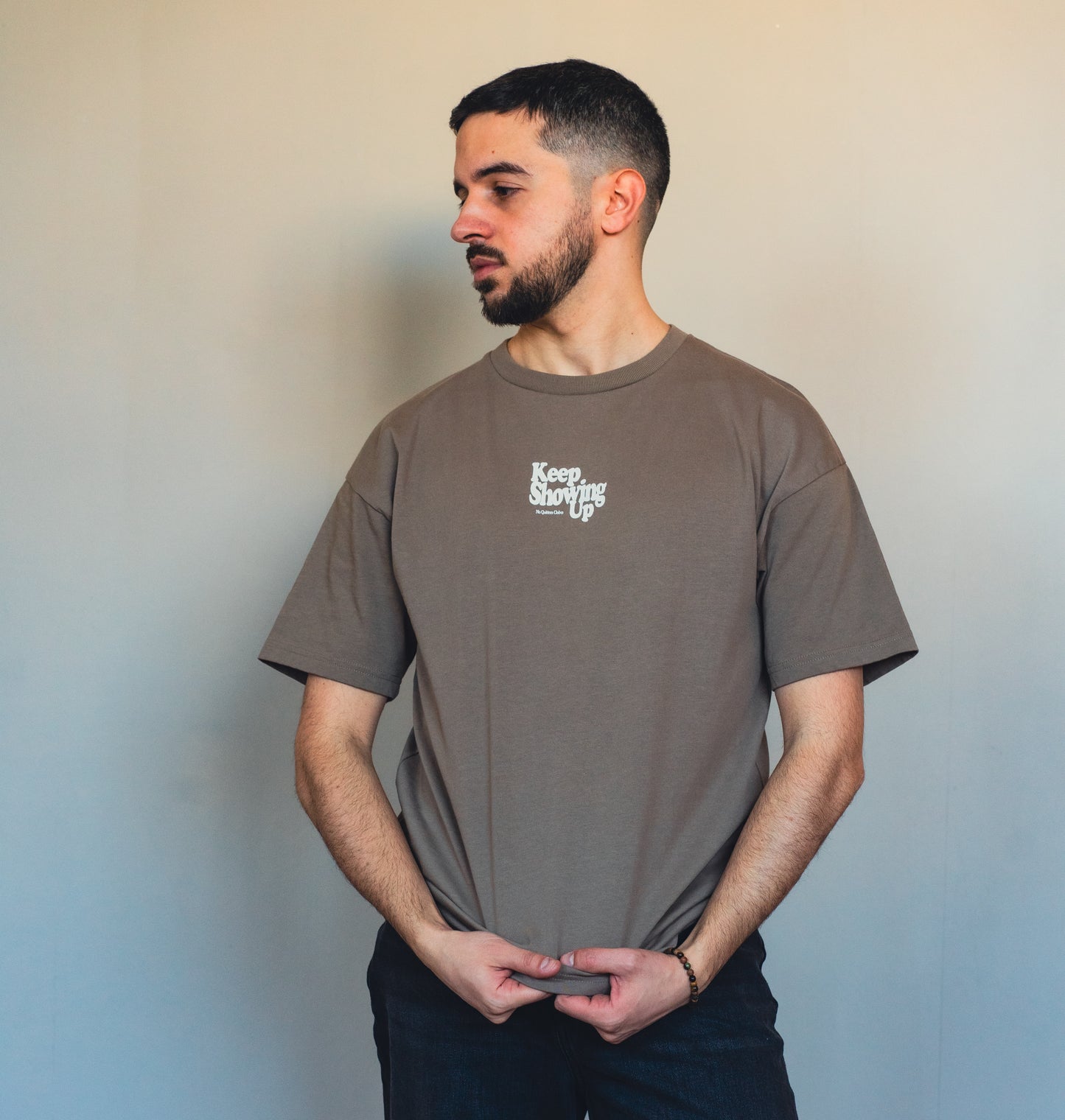 Close-up of mocha fabric and inspirational quote print on sustainable t-shirt