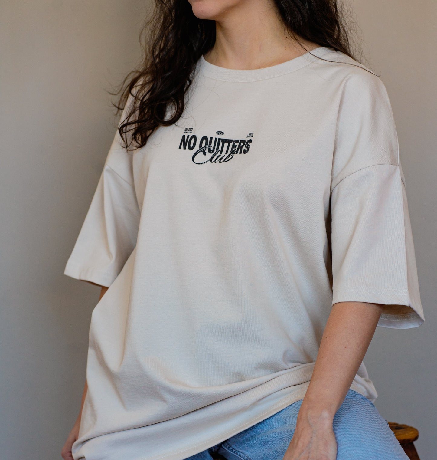 Neutral-toned streetwear t-shirt with motivational quote print, made from 100% organic cotton for comfort and style.