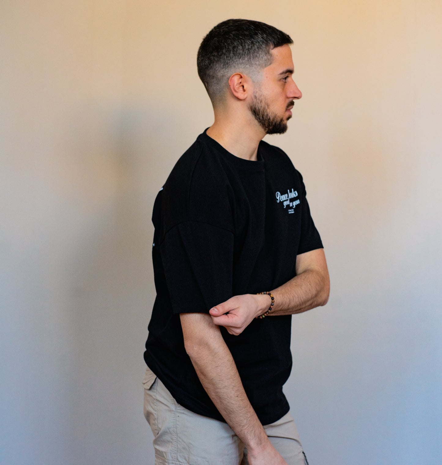 Statement quote t-shirt in black, “Peace Looks Good on You” design made with soft organic cotton — minimalist, bold, and empowering.
