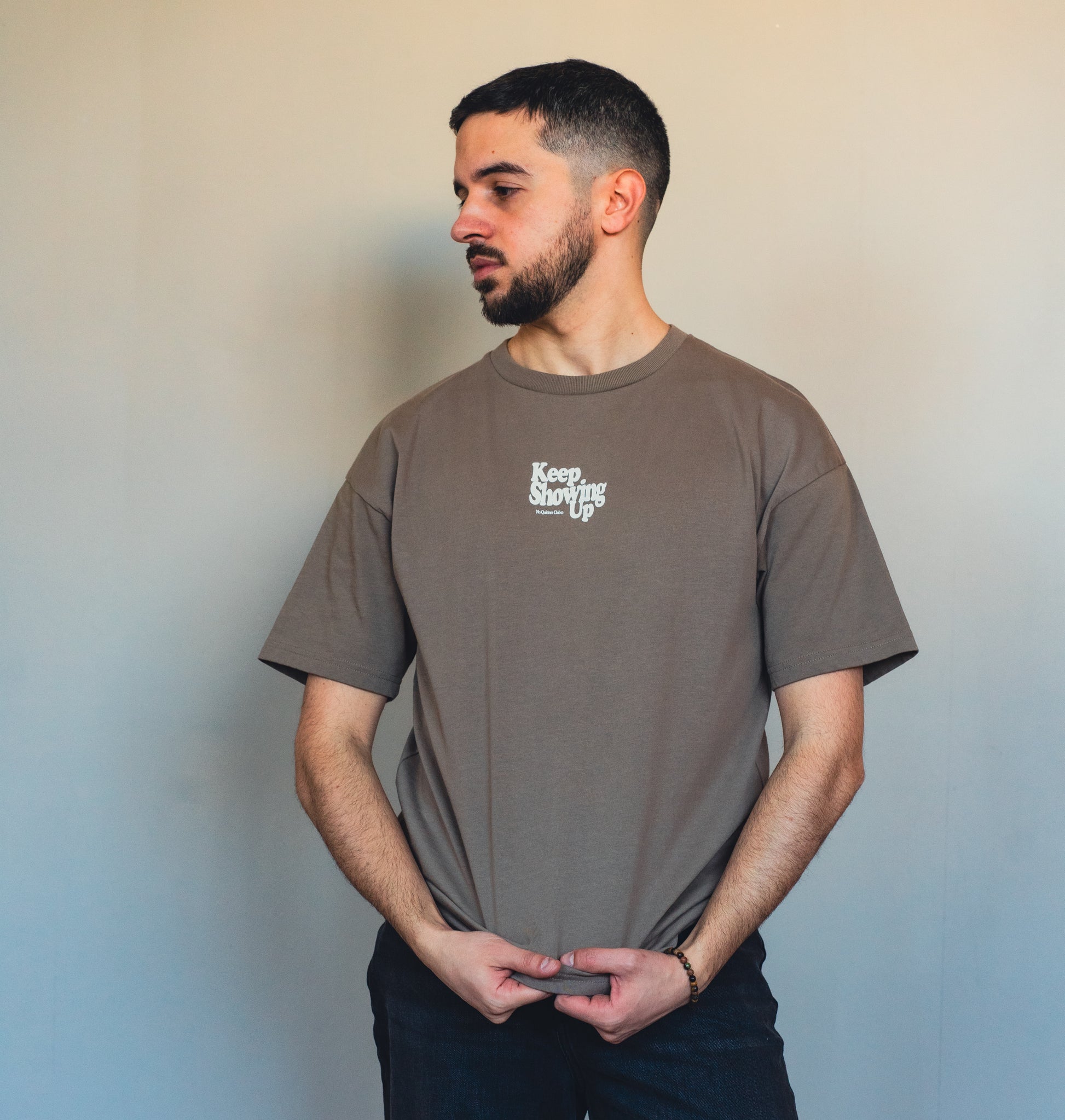 Close-up of mocha fabric and inspirational quote print on sustainable t-shirt