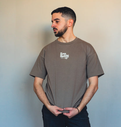 Close-up of mocha fabric and inspirational quote print on sustainable t-shirt