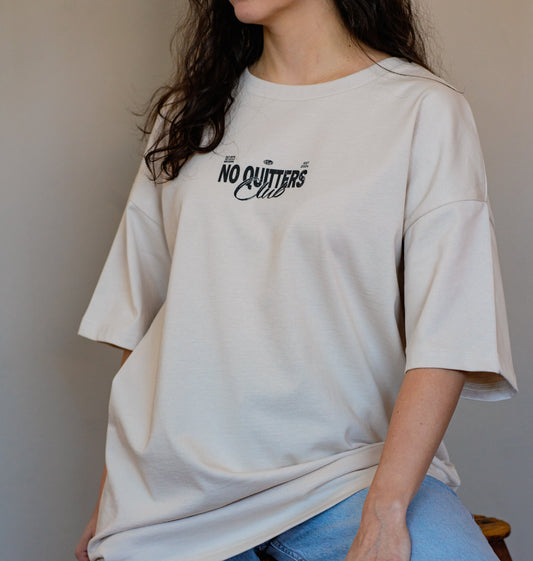 Neutral-toned streetwear t-shirt with motivational quote print, made from 100% organic cotton for comfort and style.