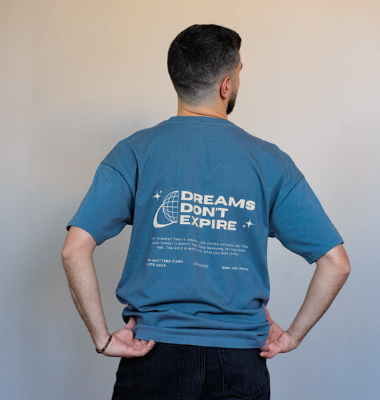 Unisex white streetwear t-shirt styled from the side, featuring bold inspirational message and relaxed oversized fit